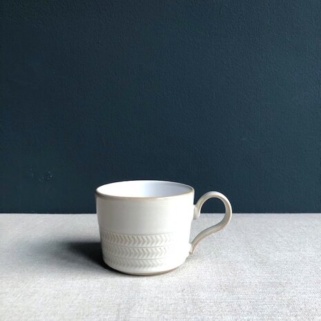 Natural Canvas coffee cup text.